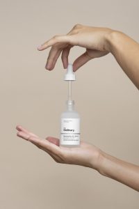 hands holding a bottle of the ordinary skincare serum forbeauty and cosmetics public relations